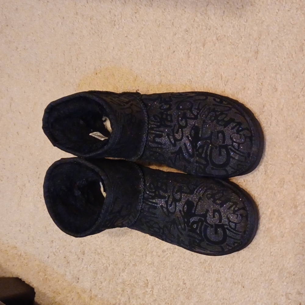 Mini ugg booties with graffiti on them